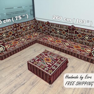 May include: A sectional sofa with a patterned design in shades of burgundy, brown, and gold. The sofa measures 75 inches (190 cm) along one side and 103 inches (260 cm) along the other. A matching square ottoman is in front. The text "Handmade by Esra" is visible.