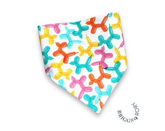 May include: A white bandana with a pattern of colorful balloon animals. The bandana has a blue, white, and black label that says "Briggs & Rory".