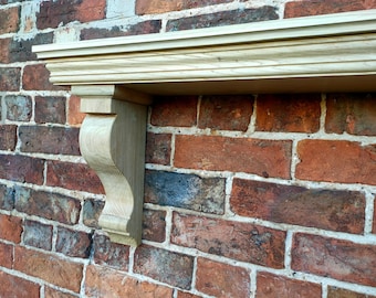 May include: A wooden shelf with a decorative, curved bracket. The shelf is mounted on a brick wall.