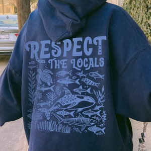 May include: Navy blue hoodie with a graphic of fish and the text "Respect the Locals".