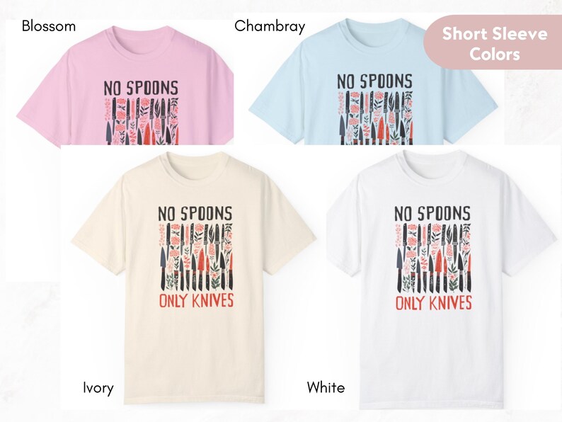May include: Four short-sleeved t-shirts in different colours: blossom, ivory, white, and chambray. Each shirt features a graphic print of a row of knives with the text "No Spoons Only Knives".