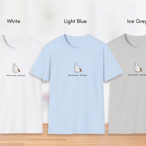 May include: Three t-shirts in white, light blue, and ice grey with a cartoon goose design and the text "Reclusive Goosey".
