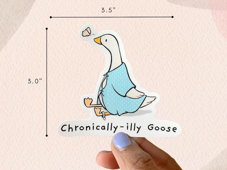 May include: A white goose wearing a light blue polka dot robe with a butterfly on its wing. The goose is sitting down with its legs crossed. The text "Chronically-illy Goose" is written below the goose. The sticker is 3 inches wide and 3.5 inches tall.