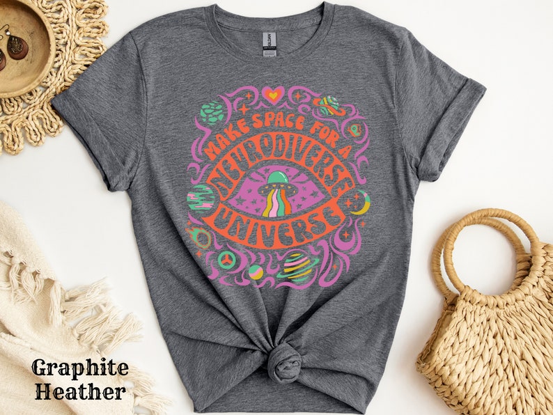May include: A dark grey t-shirt with a colourful graphic design featuring a psychedelic eye with a UFO and the text "Make Space For A Multiverse Universe".