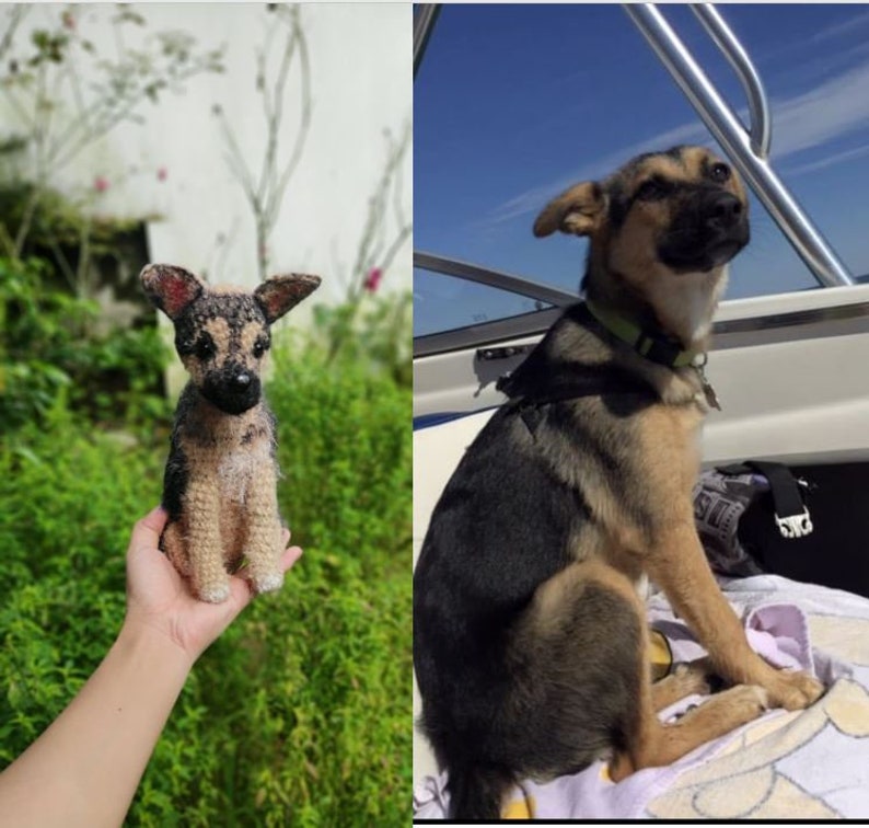 May include: A crocheted stuffed dog toy, brown and black, sitting in a person's hand. The toy is a replica of a real dog, sitting on a towel on a boat.
