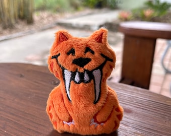 Smilodon Sez "Buy this mini Saber Tooth Tiger Plush!" Chester and Hester Approved! Dinoland U.S.A. Mini Smilodon Plushie