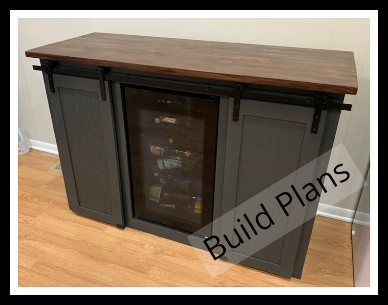 May include: A dark gray cabinet with sliding barn doors and a built-in wine cooler. The cabinet has a wood countertop and black hardware. The text "Build Plans" is visible on the cabinet.