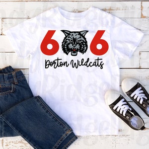 May include: White t-shirt with a red 606 and a black and gray wildcat mascot graphic. The text "Dorton Wildcats" is printed in black below the graphic.