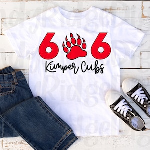 May include: White t-shirt with red numbers 606 and a red bear paw print. The text "Kimper Cubs" is written in black below the numbers.