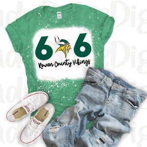 May include: Green and white bleached t-shirt with a green number "6" on either side of a yellow Viking mascot with the text "Rowan County Vikings" underneath.