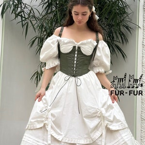 May include: A white off-the-shoulder dress with a green corset top and a ruffled skirt. The dress has a black ribbon tied at the waist.