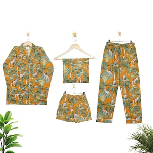 May include: A matching pyjama set in a mustard yellow colour with a tropical print featuring palm trees and animals. The set includes a long-sleeved shirt, trousers, and shorts.