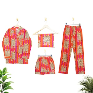 "Vibrant orange and pink vertical striped pajama set featuring a repeating tiger animal print. This 4-piece women's cotton nightwear collection includes a long-sleeve button-down shirt with collar and piping, full-length pajama pants, matching shorts, and a fabric envelope pouch. Indian block print style loungewear perfect for boho bridesmaid gifts, bachelorette parties, or summer sleepwear. Soft breathable fabric with funky safari design."