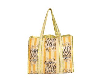 May include: Yellow and cream striped tote bag with tiger print. The bag features vertical stripes and a repeating pattern of tiger faces and bodies. The handles and edges are a solid yellow color.