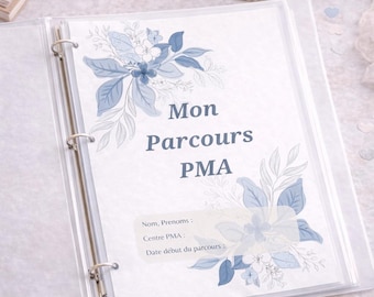 May include: Clear binder with a floral design in shades of blue and the text "Mon Parcours PMA". The binder is open, revealing a sheet with fill-in-the-blank fields. A cup of coffee, glasses, and a gold paper clip are also visible.