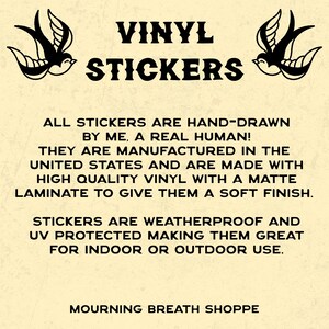May include: A beige informational sign featuring two black swallow illustrations and the text: VINYL STICKERS. ALL STICKERS ARE HAND-DRAWN BY ME, A REAL HUMAN! THEY ARE MANUFACTURED IN THE UNITED STATES AND ARE MADE WITH HIGH QUALITY VINYL WITH A MATTE LAMINATE.