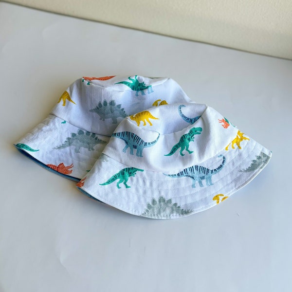 2 in 1 Reversible Dinosaur Print and Matching Blue Bucket Sun Hat for Summer, Adult and Kids Matching Mommy/ Dad and Me Wide Brim Bucket Hat