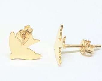 May include: A pair of gold dove stud earrings. The doves are facing opposite directions.