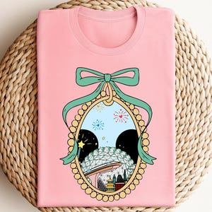 a pink t - shirt with a picture of a woman's face in a