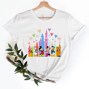 a white t - shirt with mickey mouse and friends on it