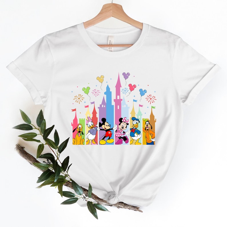 a white t - shirt with mickey mouse and friends on it