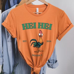 an orange shirt with a rooster on it