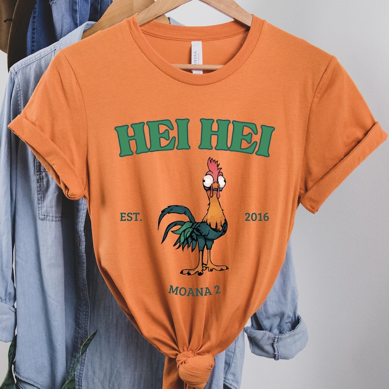 an orange shirt with a rooster on it
