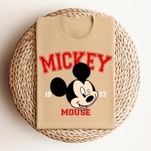 a mickey mouse shirt sitting on top of a wicker basket