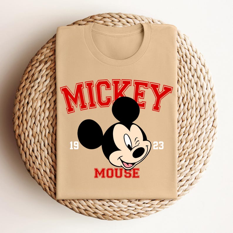 a mickey mouse shirt sitting on top of a wicker basket