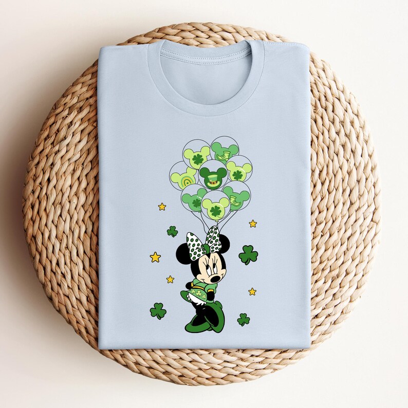 a blue shirt with a mickey mouse holding shamrocks