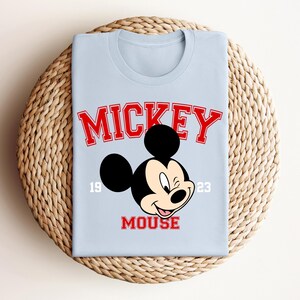 a mickey mouse shirt sitting on top of a wicker basket