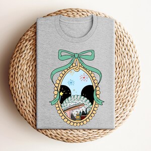 a gray t - shirt with a picture of a woman's face in a