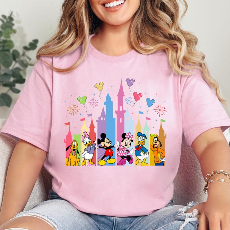 a woman sitting on a couch wearing a pink shirt