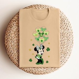 a t - shirt with a mickey mouse holding shamrocks