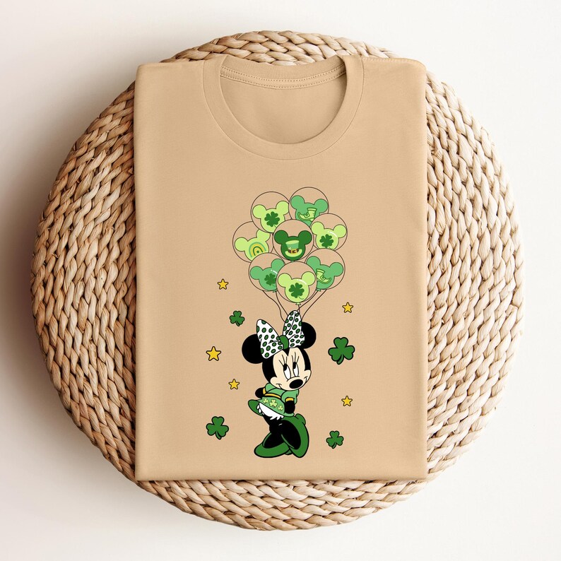 a t - shirt with a mickey mouse holding shamrocks