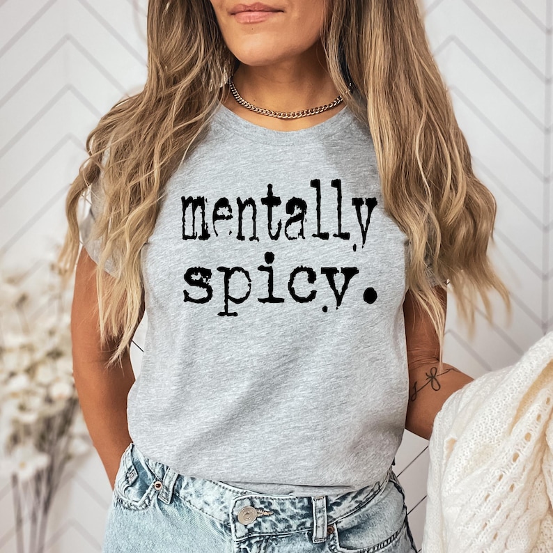 May include: A gray t-shirt with the text "mentally spicy." printed in black.