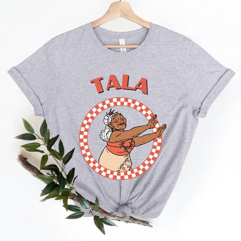 a t - shirt with a picture of a woman holding a tennis racket