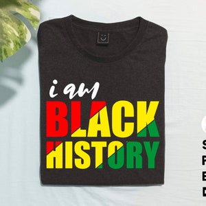 May include: Black t-shirt with the text "i am BLACK HISTORY" in red, yellow, and green. The text is in a bold, blocky font.