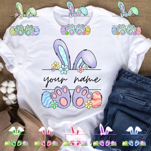 May include: White t-shirt with a design of purple bunny ears, bunny feet, and Easter eggs. The text "your name" is printed on the shirt.