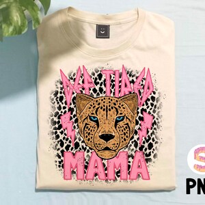 May include: A beige t-shirt featuring a pink cheetah print and the text "#TIRED MAMA" in pink lettering.