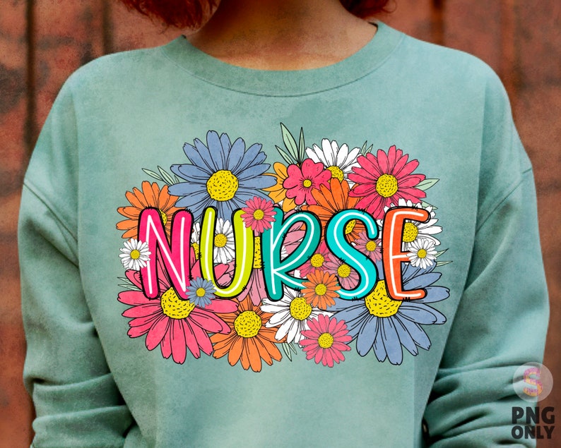 May include: A light green sweatshirt with a floral design and the word "NURSE" in colorful letters.