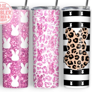 May include: Three 20 ounce sublimation tumblers with different designs. The first tumbler has a pink glitter background with white bunny silhouettes. The second tumbler has a pink glitter background with white bunny silhouettes in a leopard print pattern. The third tumbler has black and white stripes with a white bunny silhouette in a leopard print pattern.