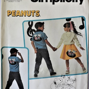 May include: A Simplicity sewing pattern envelope, number 7506, size A (3-8), featuring Peanuts characters. The cover displays a blue shirt and a yellow skirt with Snoopy and Woodstock graphics, alongside a line drawing of the characters dancing.