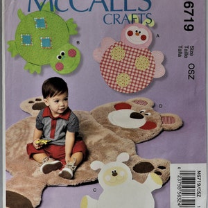 May include: McCall's Crafts sewing pattern M6719 for plush animal floor mats. The envelope features illustrations of a green turtle, a pink ladybug, a white lamb, and a brown bear mat, with text including McCall's Crafts, M6719, and Size OSZ.