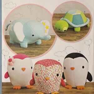 May include: Simplicity sewing pattern 8069 for DIY Fluffies, featuring illustrations of a light blue elephant, a green turtle, and three penguin-like creatures in pink, white, and multi-colored patterns with orange beaks and feet.