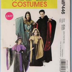 May include: McCall's Costumes sewing pattern MP446 for kids sizes 5-12. The envelope features illustrations of three costumes: a witch with a purple-trimmed black robe and hat, a hooded tan robe, and a black cape with a red lining over a black robe.