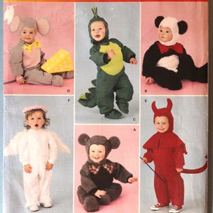 May include: Simplicity pattern 2506 for toddler costumes in sizes 1/2, 1, 2, 3, 4. The envelope displays six costume variations: a mouse with cheese, a green dinosaur, a panda, an angel with wings, a dark mouse, and a red devil with a tail.