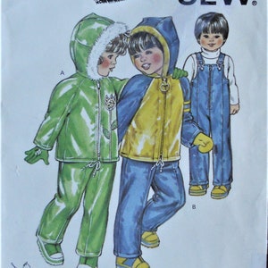 May include: Kwik Sew pattern 1284 for children's clothing, featuring illustrations of hooded jackets and overalls. The pattern includes a green hooded jacket with white trim, a blue and yellow hooded jacket, and blue denim-style overalls with a zipper.