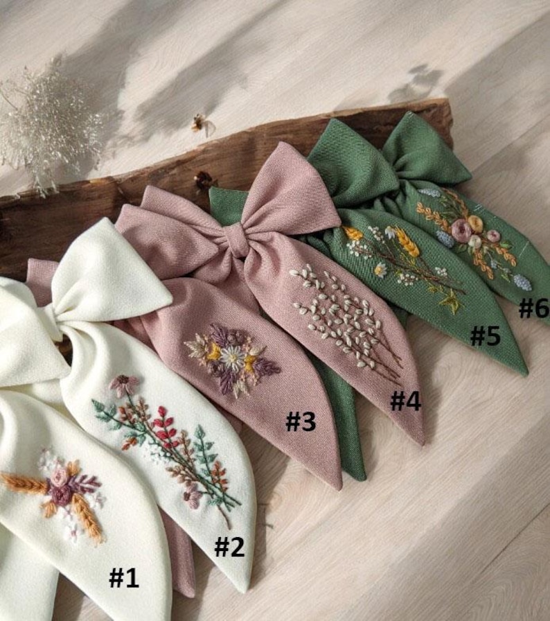 Puede incluir: Seis lazos para el pelo hechos a mano de tela con dise&ntilde;os florales bordados en tonos verdes, rosas y blancos. Los lazos est&aacute;n numerados del 1 al 6.