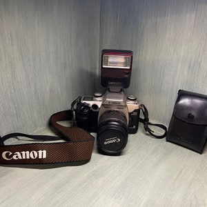 Canon EOS ELAN 2 E 35mm Camera with Canon EF 28-80mm lens. Also has a 277T Canon Speedlite Flash.